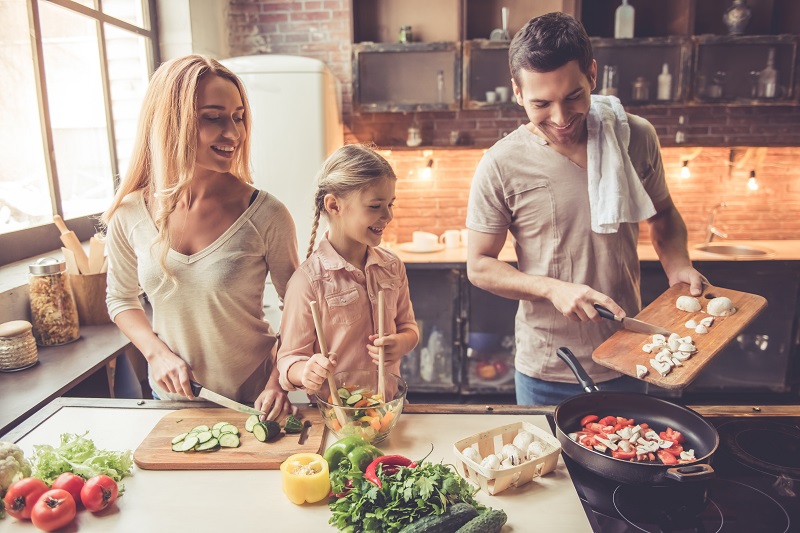 Family cooking healthy vegetarian meal