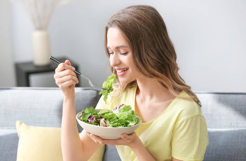 Woman eating salad.